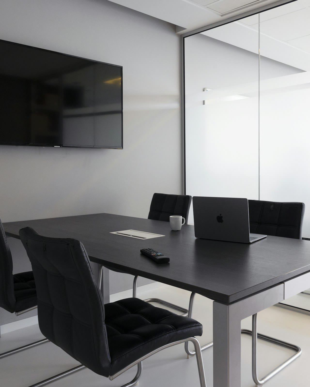 Boardroom with a wall display and ceiling microphones
