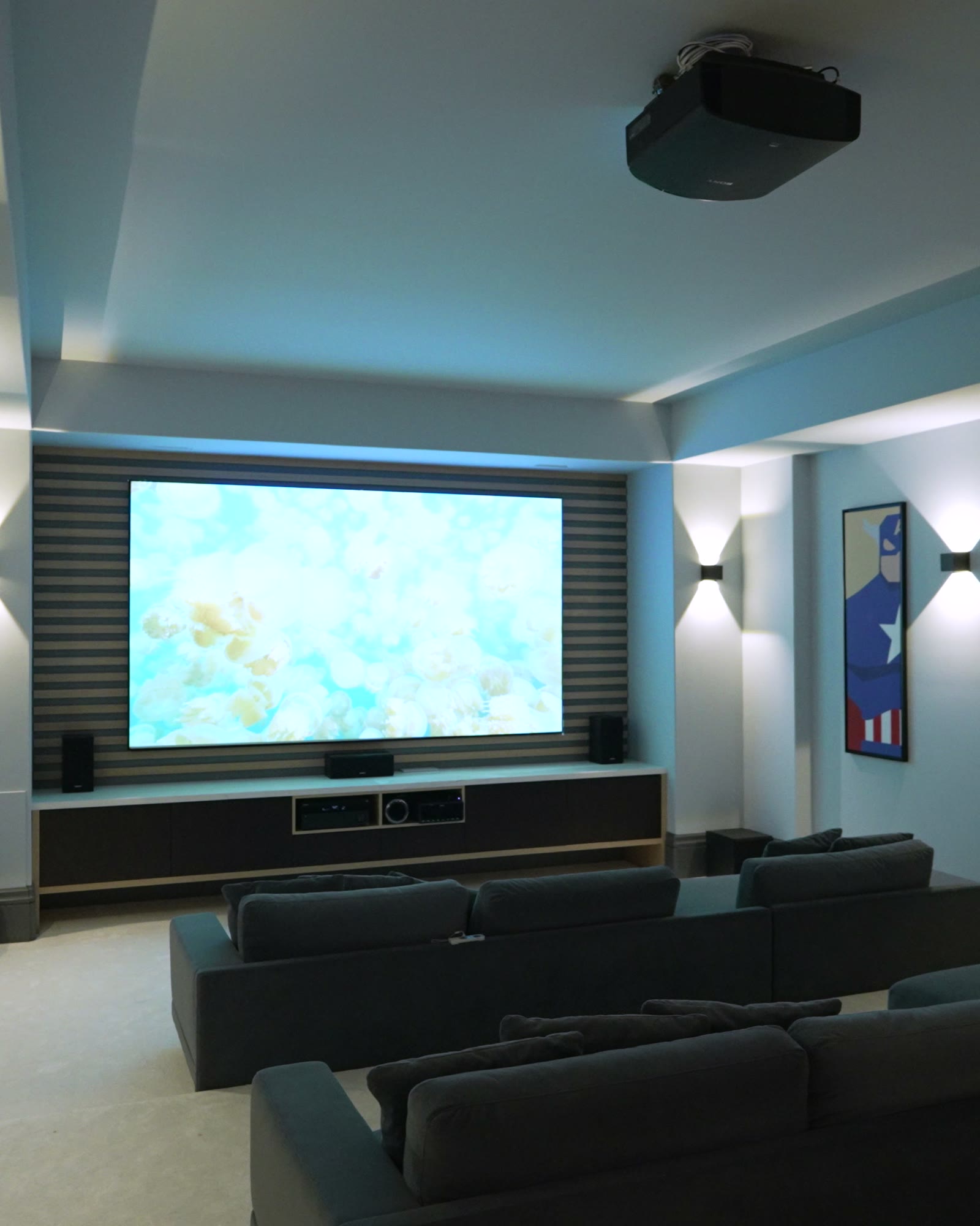 Private cinema room with a recessed screen and tiered seating
